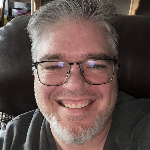 Clifton McNeill, RN, smiling, wearing glasses